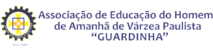 Image of a logo featuring a gear with a cross symbol and human figures in the center. To the right, it contains the text "Associação de Educação do Homem de Amanhã de Várzea Paulista 'GUARDINHA.'" At the bottom of the gear, it says "Desde 1969.