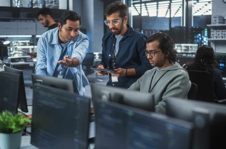 Team,Of,Three,Multiethnic,Diverse,Software,Developers,Talk,,Discuss,And